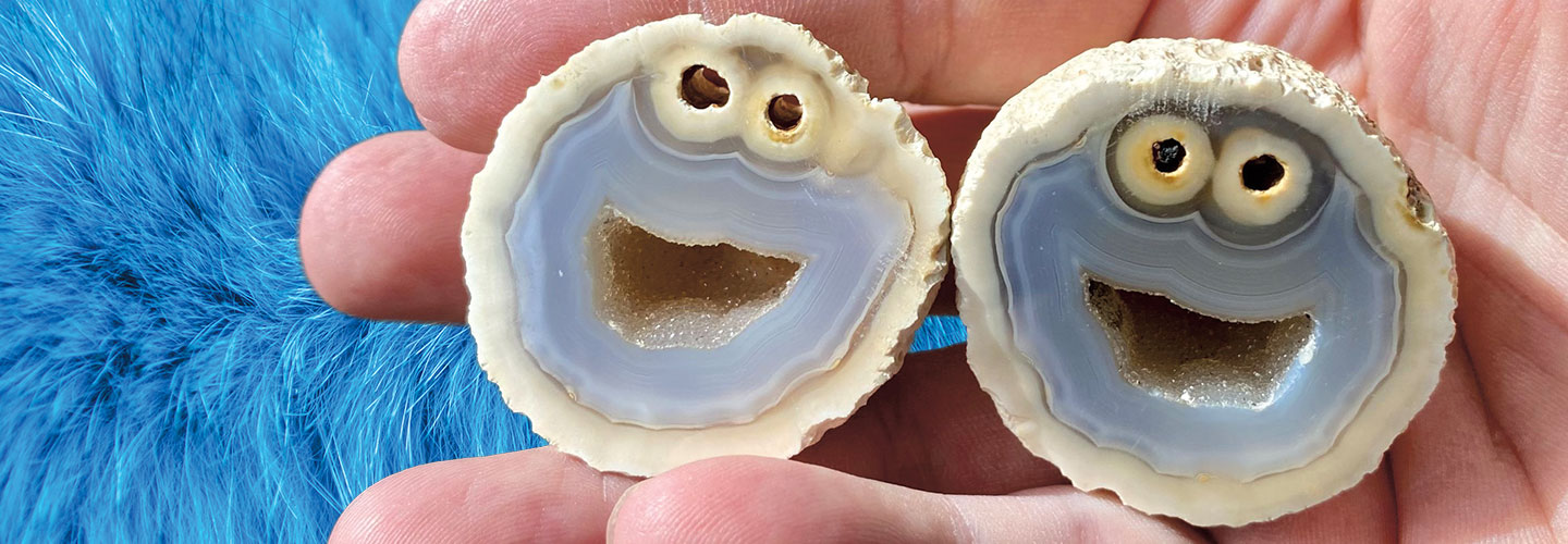 Two halves of an agate look like a cartoon character with two eyes and a smiling mouth.