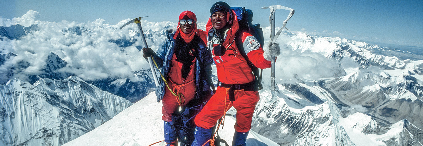 Climbers pose on the top of Mount Everest.