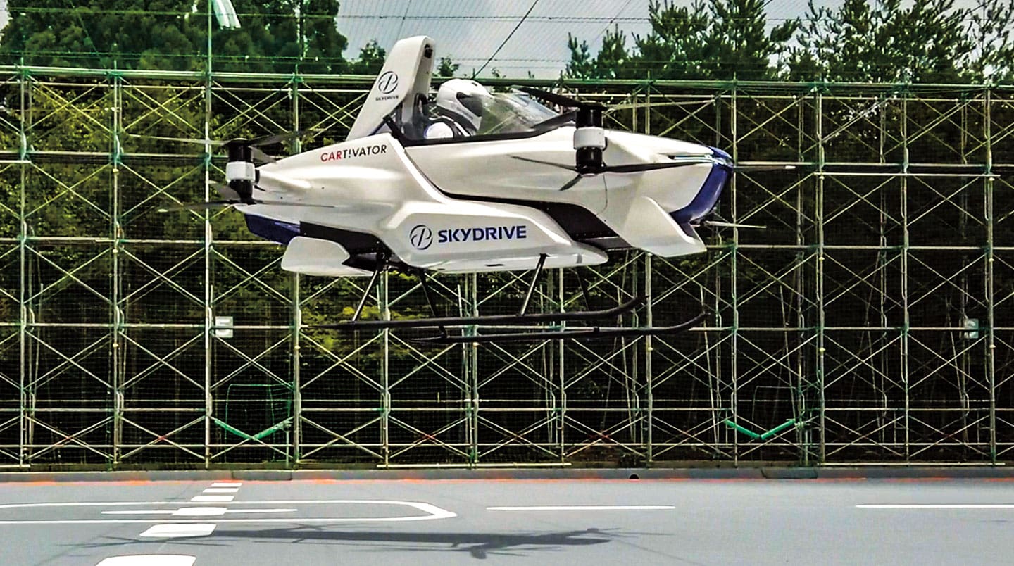 A SkyDrive car flies in the air.