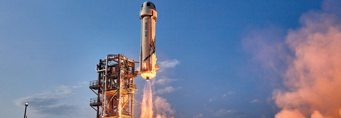 The Blue Origin rocket taking off.