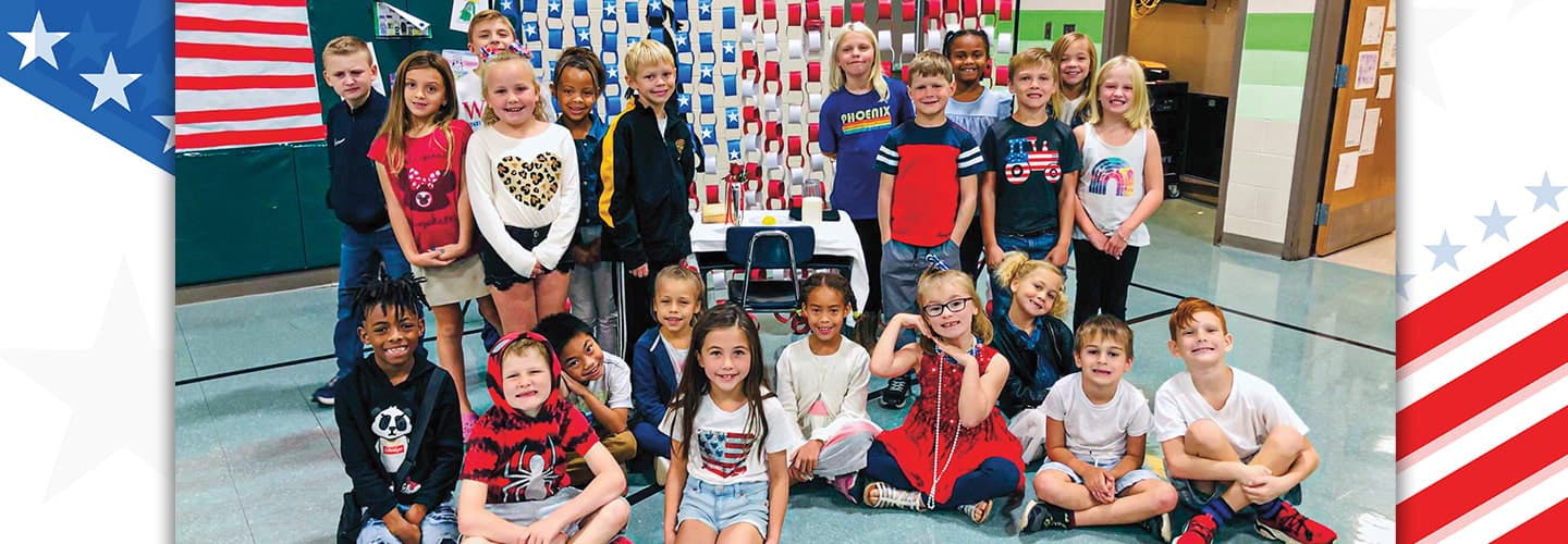 Photo of a class of students wearing red, white, and blue