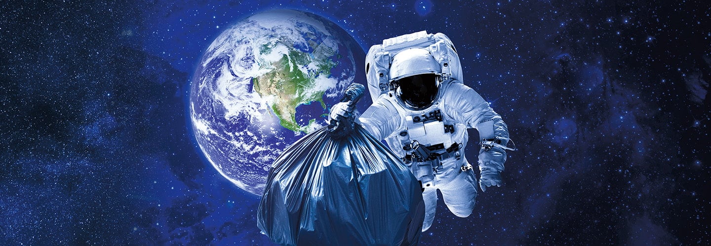 an astronaut holds a garbage bag while floating in space