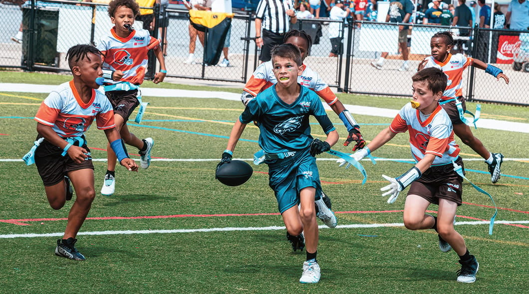 a group of boys playing flag football